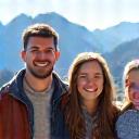 The Miller Family smiling in front of an alpine view.