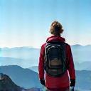 Solo traveler Sarah K. on a mountain peak.